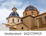 Exterior of Altea Church, also known as the Church of Nuestra Senora del Consuelo - Our Lady of Consolation, viewed from Carrer Sant Miguel in the old town area in Altea, Spain.