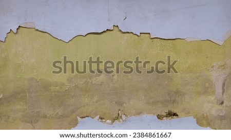 Exterior Background of an Old Cement Wall with Peeling and moldy Paint. Cracked wall.