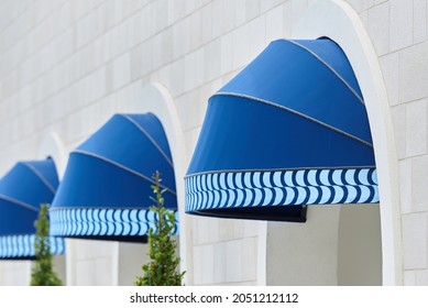 Exterior Blue Round Awning Mounted In Arch