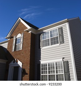 Exterior Of Brick And Vinyl Siding House.