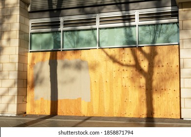 Exterior Of Business, Store, Restaurant Permanently Closed And  Boarded Up With Plywood Sheets