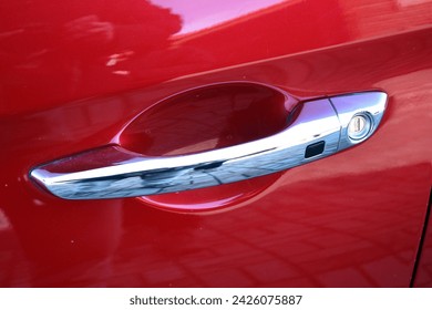 Exterior chrome car door handle with keyless entry button. Keyless entry car door handle with keyless go touch sensor. Automatic opening of a car door without a key. Car door handle. Access button.