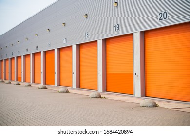 Exterior Of A Commercial Warehouse With Orange Roller Doors