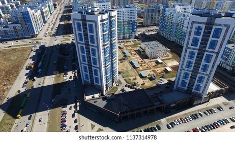 Exterior Day Time Establishing Shot Of Generic Urban City Brick Apartment Building High Rise Affordable Housing Complex. Skyline City View Of Modern Metropolis. 