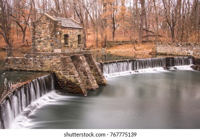 Exterior Daytime Long Exposure Stock Photo Of Stone Structure On Dam And Waterfall On Speedwell Lake In Morristown, New Jersey In Morris County On Overcast Fall Day