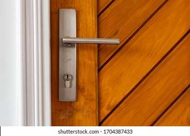 Exterior Door Handle And Security Lock On Wooden Door