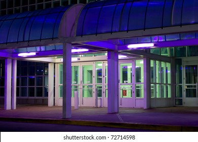 Exterior Entrance To Office Building Lit With Purple And Green