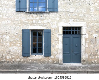 Exterior Of A French House With Wooden Window Shutters