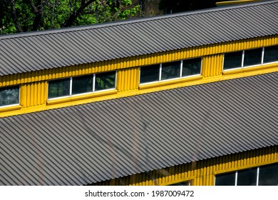 Exterior Gable Double Roof With Windows Covered With Iron Sheets Yellow Industrial Warehouse Building With Protective Gray Coating, Outdoors Top View.