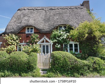 Exterior And Garden Of A Beautiful Old Traditional English Cottage House