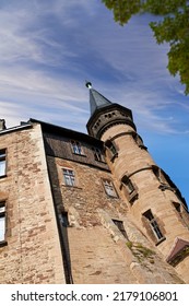 Exterior Of A Gothic Victorian Building In The Style Of England Gothic Revival On A Cloudy Blue Sky With Copy Space. Low Architecture Detail Of An Historical Church Tower Structure Or University