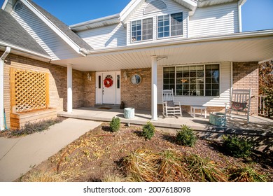 Exterior Of A House With Messy Front Yard Garden And Bricks