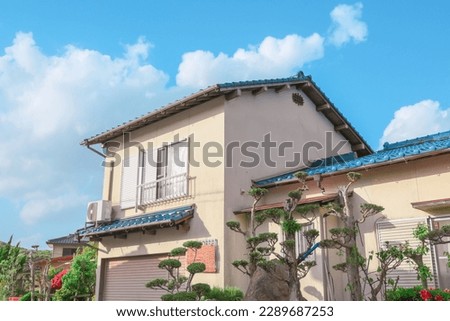 Exterior of Japanese house in countryside with blue sky.