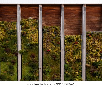 The Exterior Of A Large Industrial Building With Plants And Fauna Growing On Its Side On A Living Wall Or Vertical Garden For Net Zero And Carbon Neutral Concept