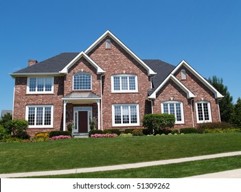 Exterior of a large two story brick residential home containing plenty of copy space,