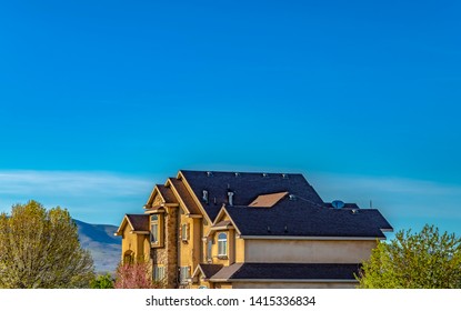 Exterior Of Lavish House With Mountain And Blue Sky Background On A Sunny Day