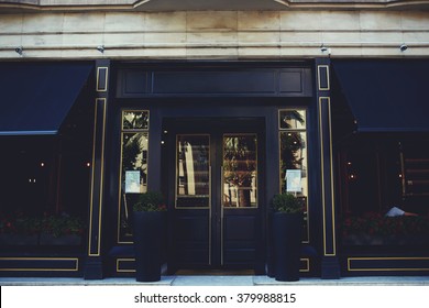 Exterior of luxury restaurant made of black wood with copy space area for your advertising text message or promotional content, central entrance to the prestigious expensive hotel in urban scene
