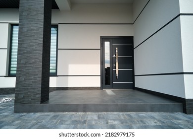 Exterior of modern contemporary comfortable house with front porch, stylish door, paved yard and shuttered windows - Shutterstock ID 2182979175