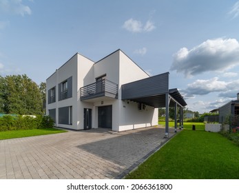 Exterior of modern luxury private house. Garage entrance. Canopy. Blue sky. Sunny day. - Powered by Shutterstock