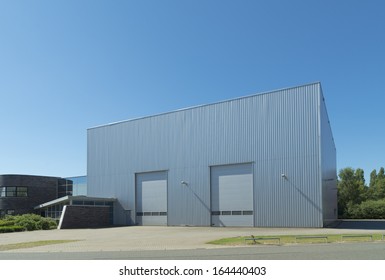 Exterior Of A Modern Warehouse With Double Roller Doors