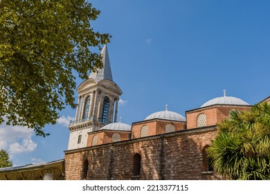 Exterior Of Mosque With Spire Against Blue Sky.