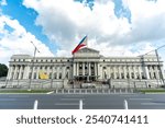 The exterior of the National Museum of Philippine Fine Arts in Manila, Philippines, with the Philippine flag.