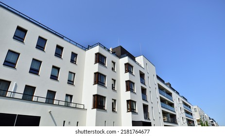 Exterior Of New Apartment Buildings On A Blue Cloudy Sky Background. No People. Real Estate Business Concept.