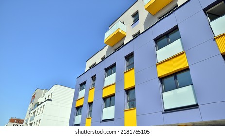 Exterior Of New Apartment Buildings On A Blue Cloudy Sky Background. No People. Real Estate Business Concept.