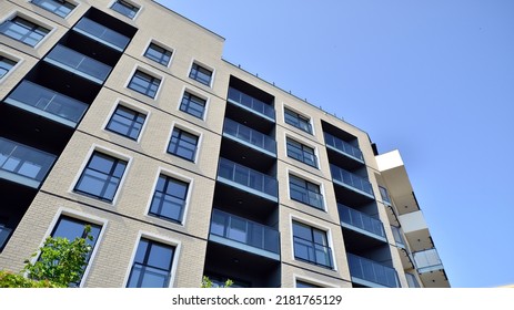 Exterior Of New Apartment Buildings On A Blue Cloudy Sky Background. No People. Real Estate Business Concept.