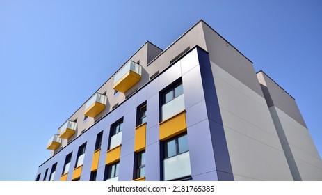 Exterior Of New Apartment Buildings On A Blue Cloudy Sky Background. No People. Real Estate Business Concept.