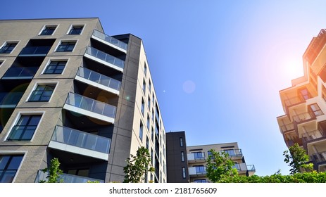 Exterior Of New Apartment Buildings On A Blue Cloudy Sky Background. No People. Real Estate Business Concept.