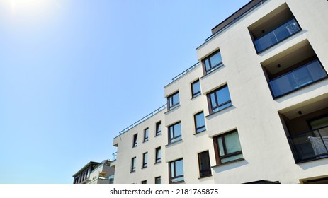 Exterior Of New Apartment Buildings On A Blue Cloudy Sky Background. No People. Real Estate Business Concept.