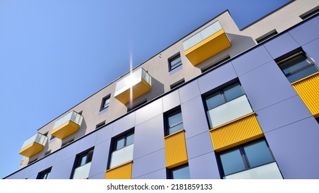 Exterior Of New Apartment Buildings On A Blue Cloudy Sky Background. No People. Real Estate Business Concept.