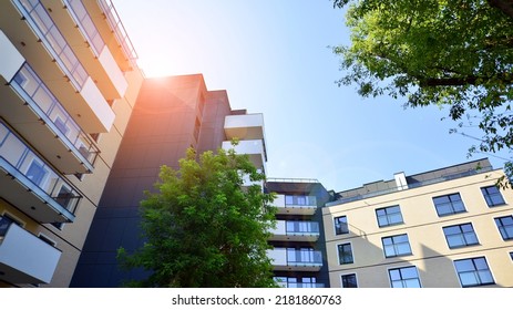 Exterior Of New Apartment Buildings On A Blue Cloudy Sky Background. No People. Real Estate Business Concept.