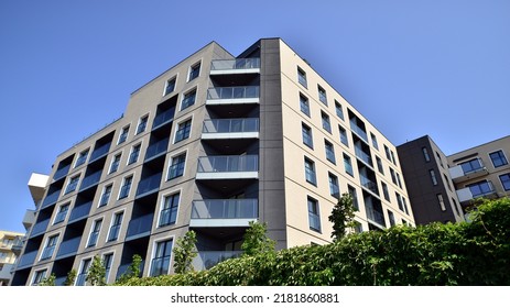 Exterior Of New Apartment Buildings On A Blue Cloudy Sky Background. No People. Real Estate Business Concept.