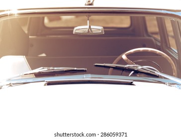 Exterior Of The Old Automobile With Windshield Wipers, Steering Wheel And Front Window. Retro Car In Vintage Toned Effect With Copy-space For Text. Oldtimer Automobile, Front View.