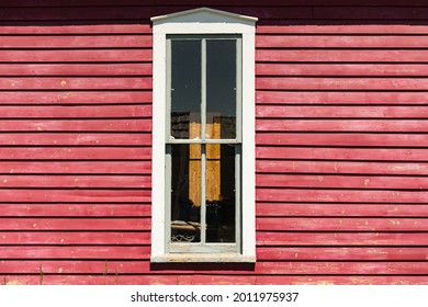 Exterior Of Old White Painted Window On Bright Red Clapboard House