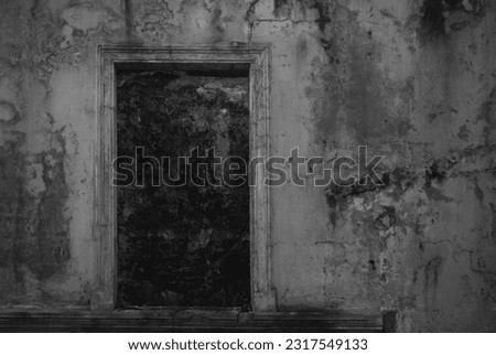 exterior of old window on a wall. retro. aged dirty wall with door, dark window. european old town, details of old city, authentic wall and window. dusk empty doorway. Darkness. cracked plaster. 