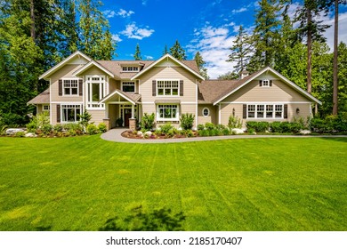 Exterior photo of luxurious house on landscaped lot with blue sky green foliage craftsman style windows vaulted entry 