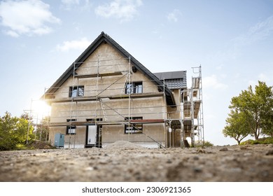 Exterior of a single family house under construction - Shutterstock ID 2306921365