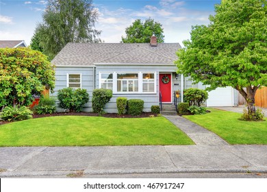 Exterior Of Small American House With Blue Paint And Red Entrance Door. Northwest, USA