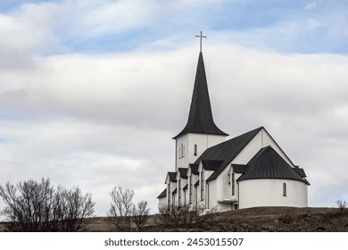 exterior of small white church in Iceland countryside  - Powered by Shutterstock