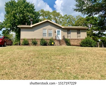 Exterior Of Starter Home DIY Renovation. Remodeled With Metal Roof And New Landscaping.