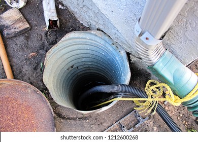 An Exterior Sump Pump Installed Next To A House