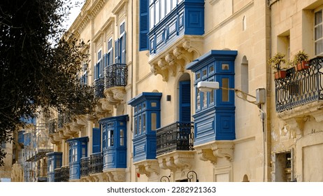 Exterior typical houses the Mediterranean island Malta  Typical residential houses in the cities in Malta  multiple floors   colorful wooden balconies   beautiful limestone buildings 