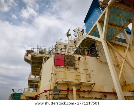 Exterior view of the aft accommodation structure of a cargo ship, highlighting industrial ship architecture and onboard living quarters design.