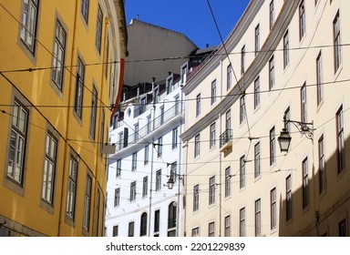 Exterior View Of Beautiful Historical Buildings In Central Lisbon, Portugal, Europe. Colorful Mediterranean Street With Colorful Houses In The Old Town Of The Portuguese Capital. Urban Neighborhood.