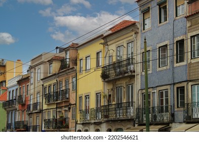 Exterior View Of Beautiful Historical Buildings In Central Lisbon, Portugal, Europe. Colorful Mediterranean Street With Colorful Houses In The Old Town Of The Portuguese Capital. Urban Neighborhood.