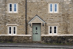 Exterior View Of A Beautiful Old Stone Cottage House On A Street In An English Town