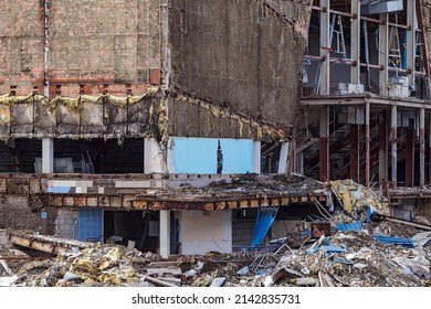 Exterior view of the destroyed building. Collapsed building. Demolished building with debris. Ruin demolishing site after destruction.